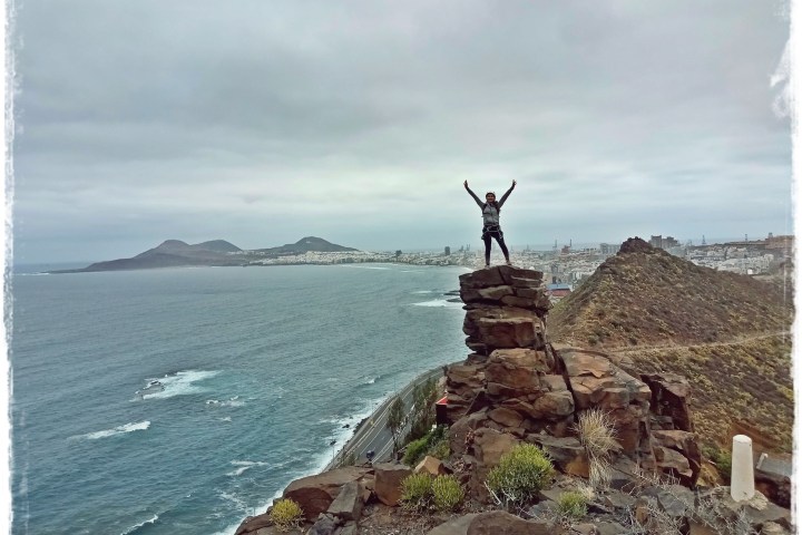 a person standing on the rocks on top of a rocky mountain