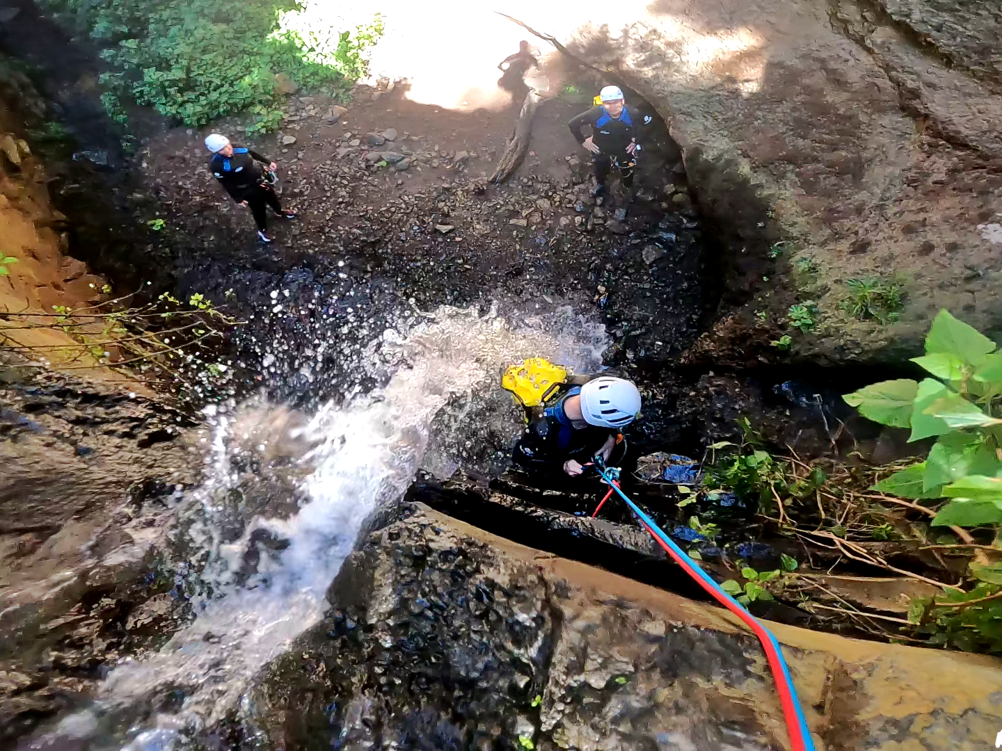 a group of people canyoning